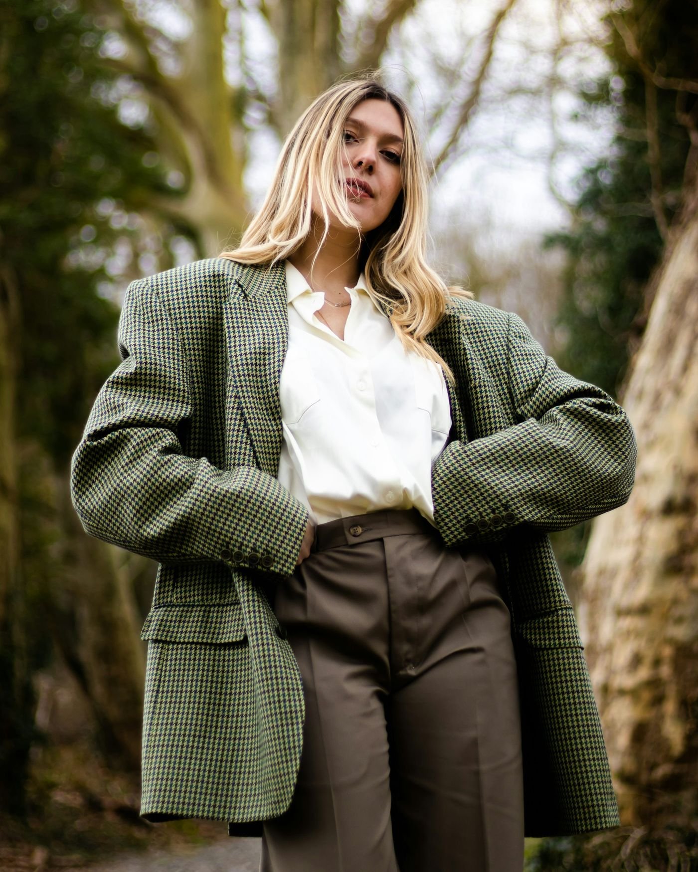 Woman styling a bold Glamoratti blazer with tailored trousers and statement accessories