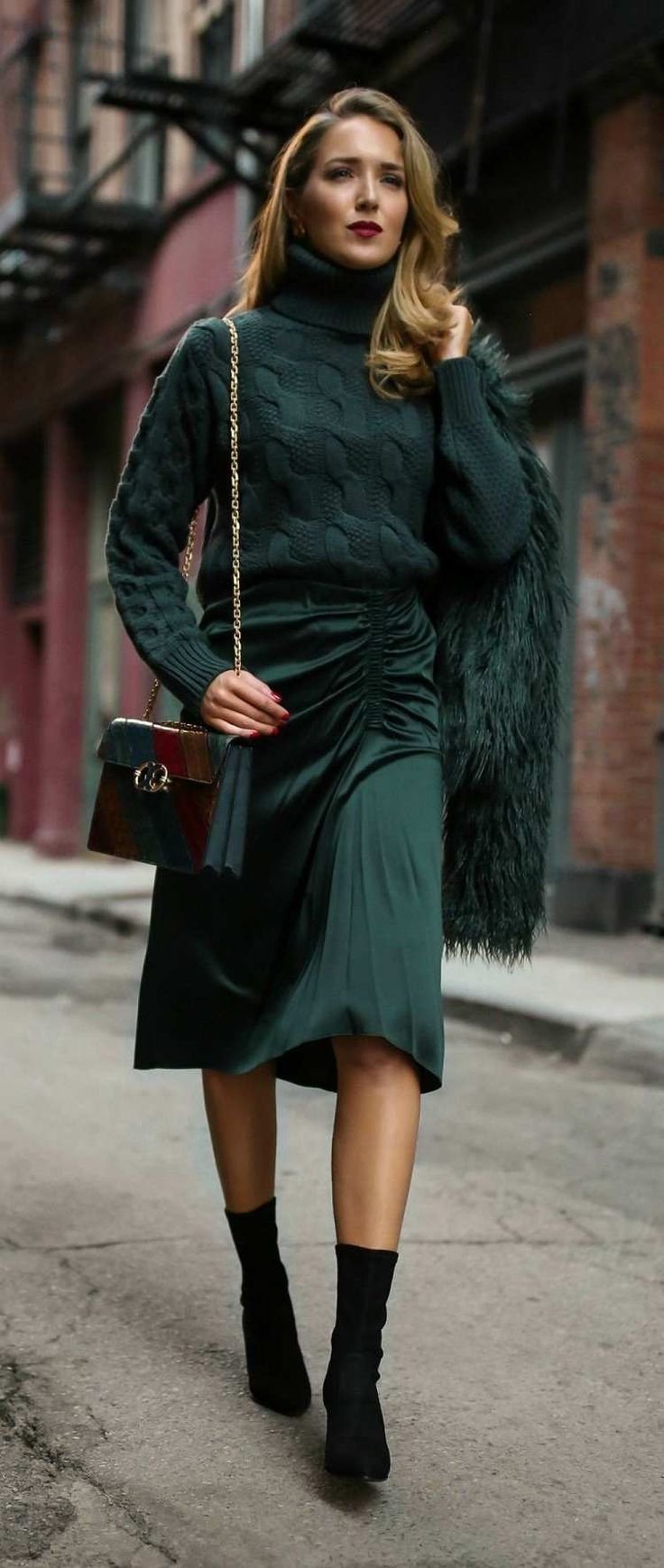 Jewel-tone outfit flat lay with emerald blazer, burgundy blouse, and gold accessories