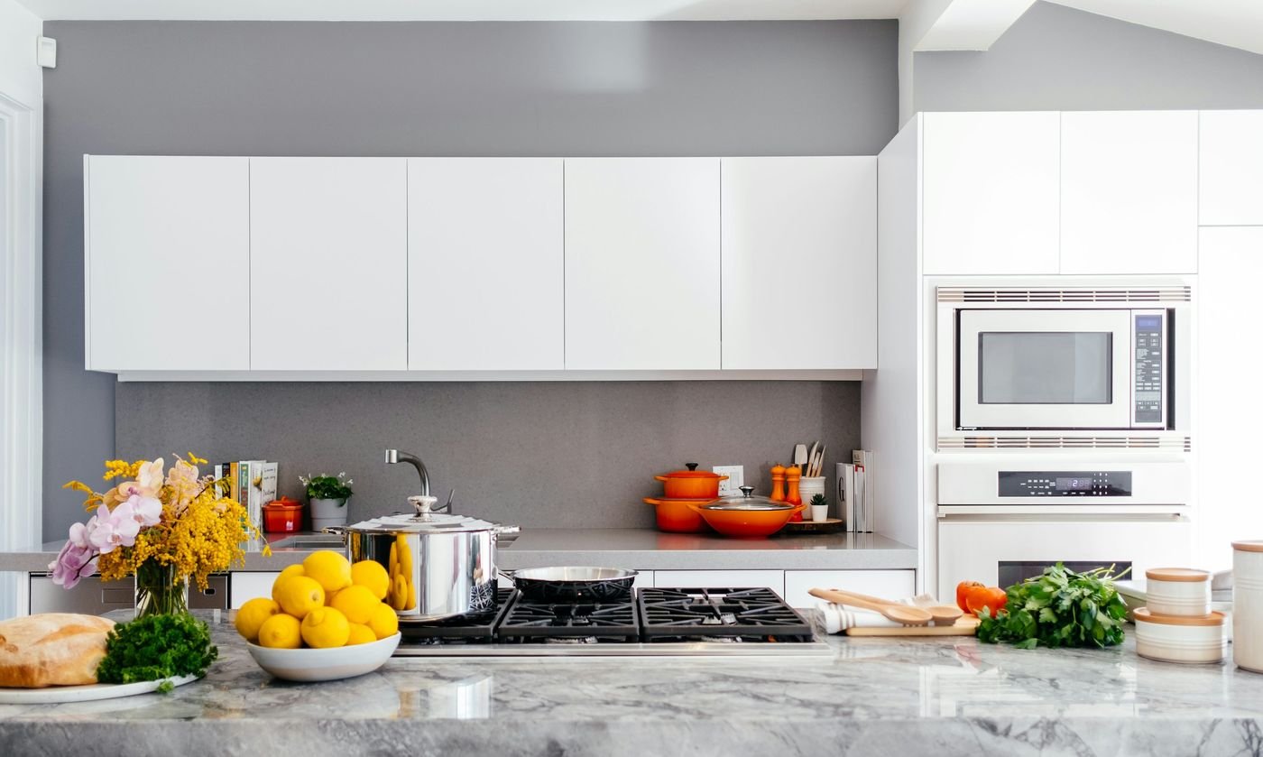 White kitchen interior with warm lighting and organized shelves