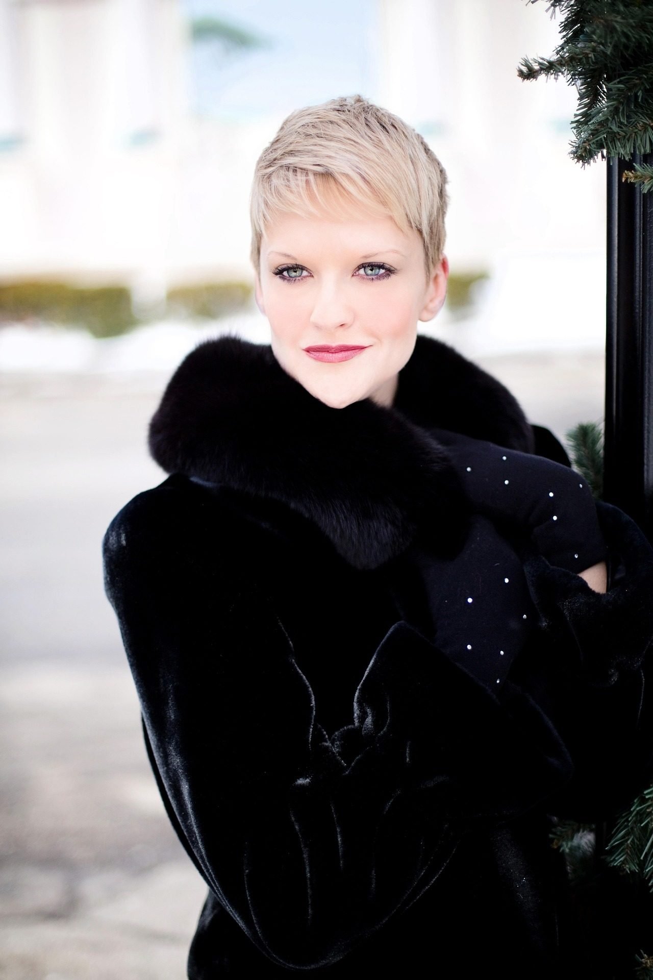 Woman over 50 wearing a very short blonde pixie cut