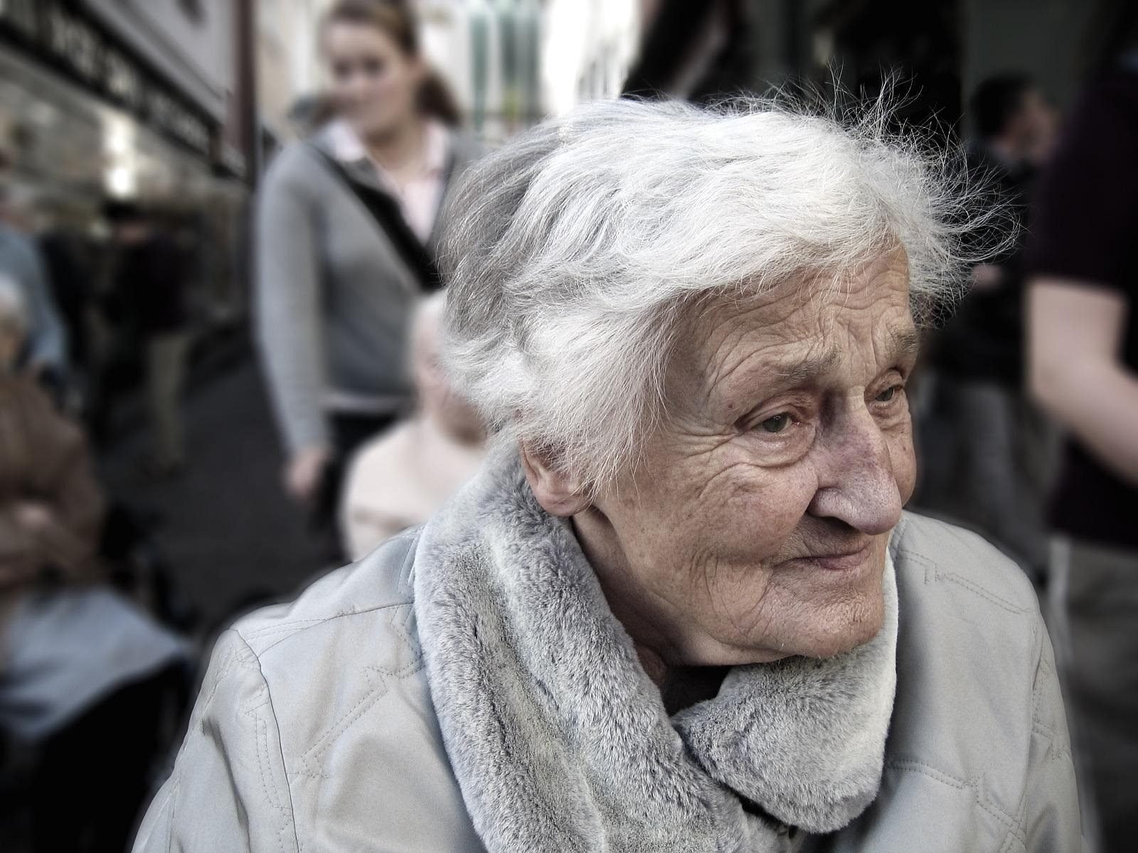 Senior woman with gray hair and a scarf outdoors