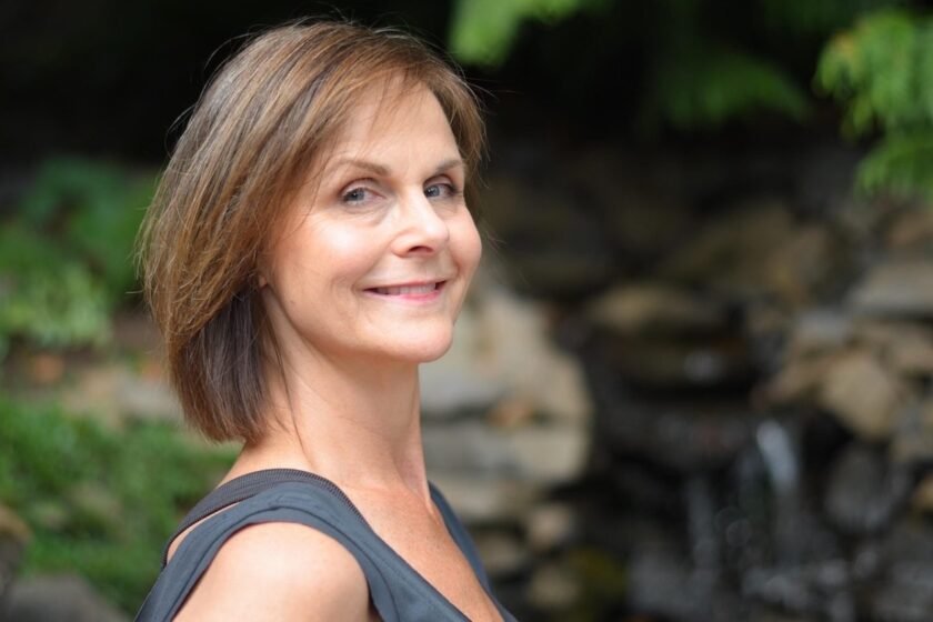 Woman Over 50 With Shoulder-Length Layered Hair Smiling