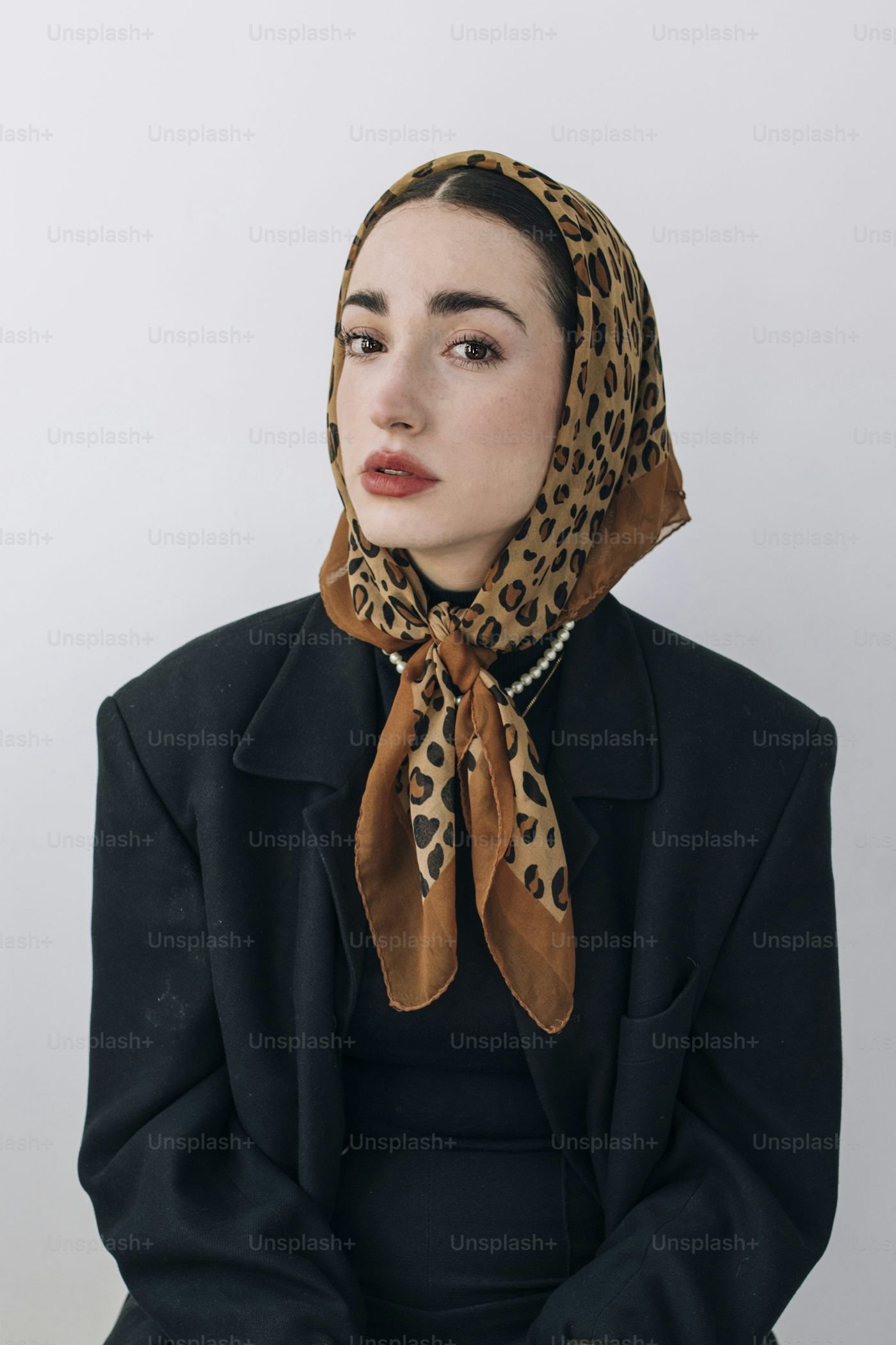 Flat lay of three silk scarves in different sizes and prints with fold guides