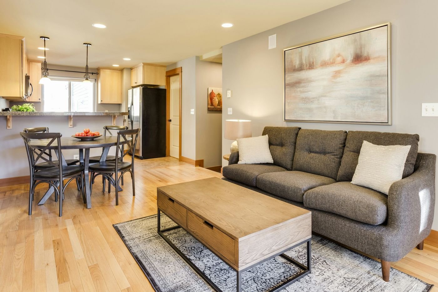 Compact apartment living room with space-saving furniture and neutral decor